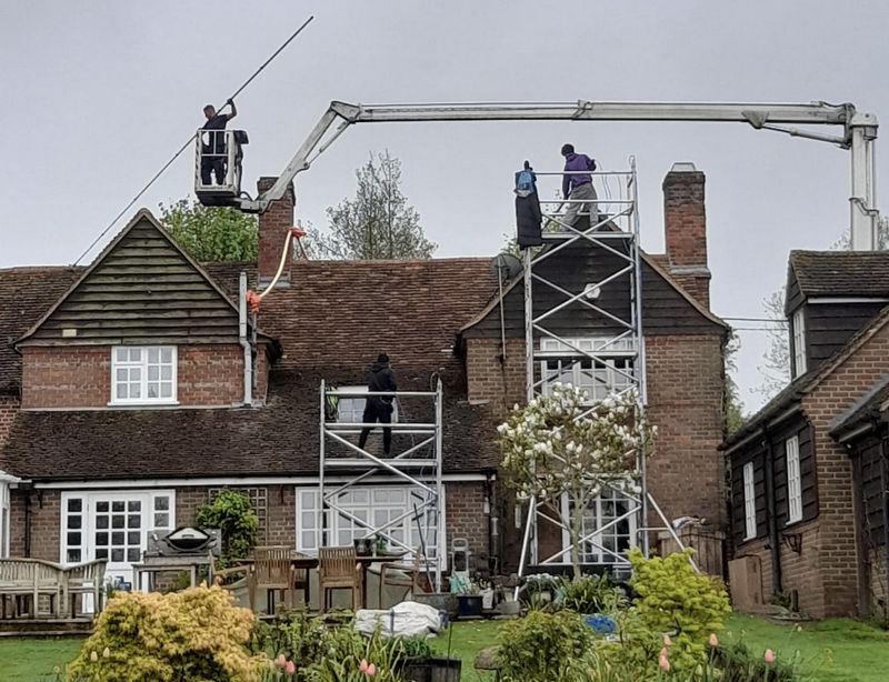 The Roof Moss Cleaners using cherry picker and scaffolding to clean roof safely and professionally in Caterham, Surrey